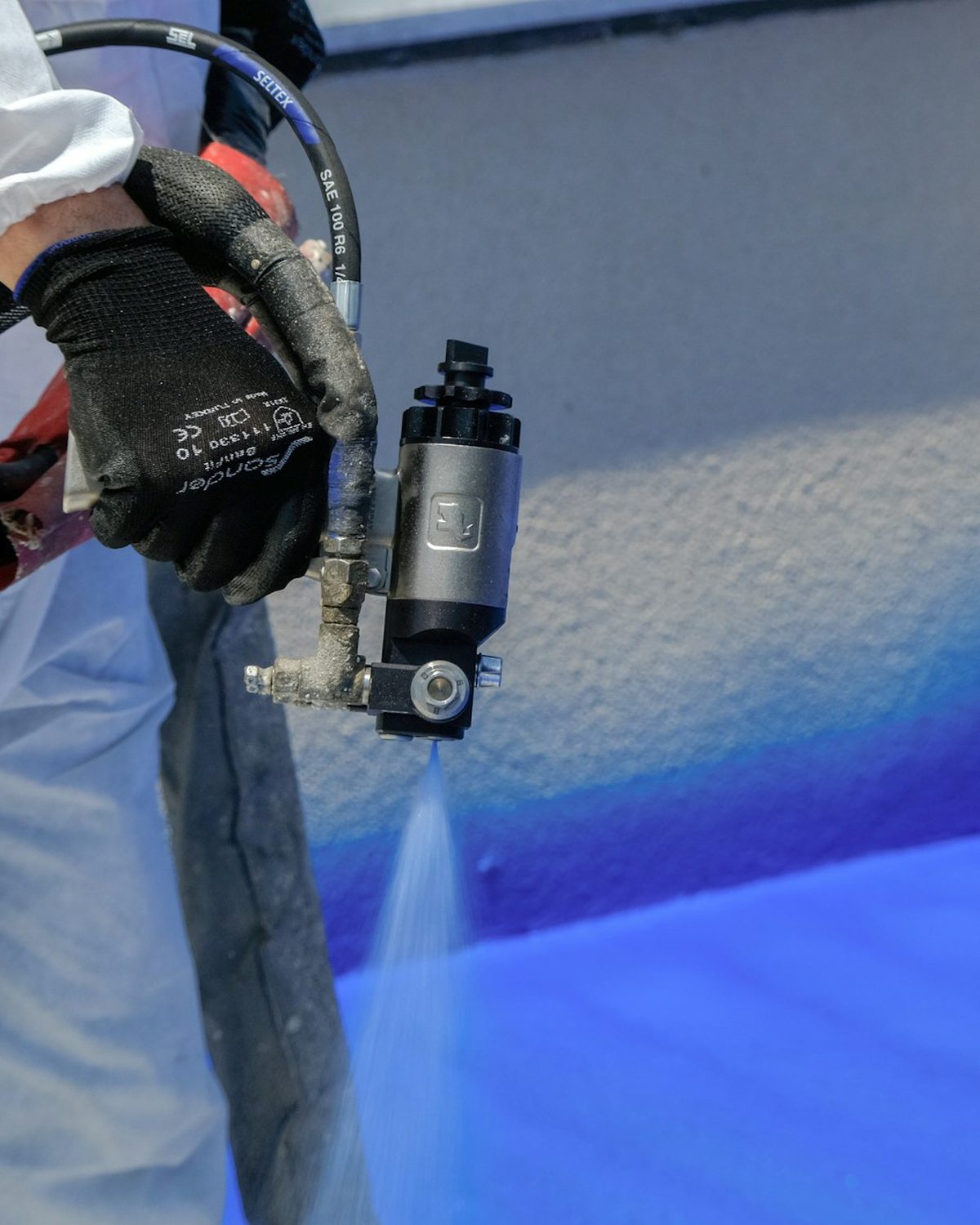 Powder coating being applied to a metal part